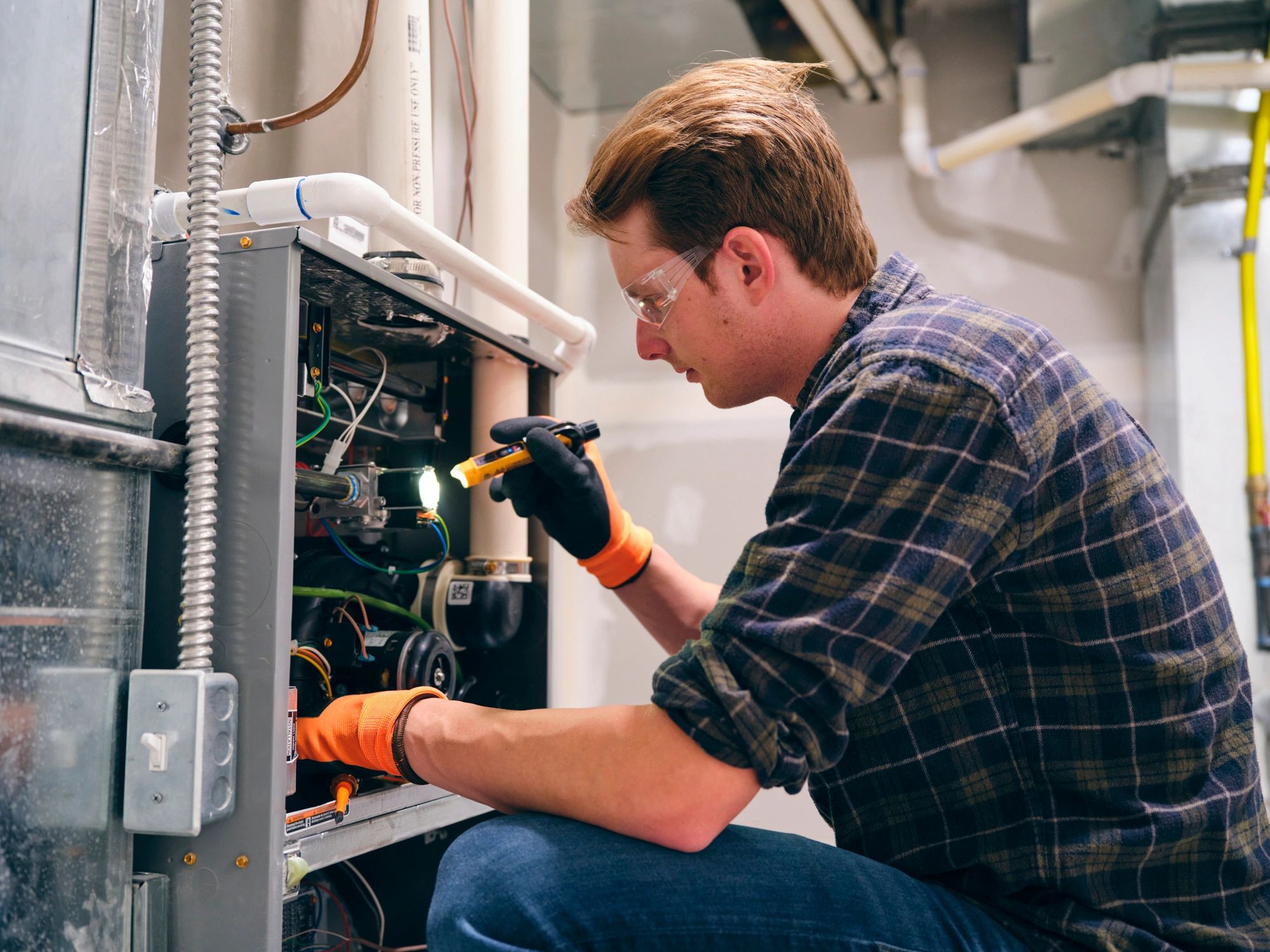 HVAC technician servicing a home furnace