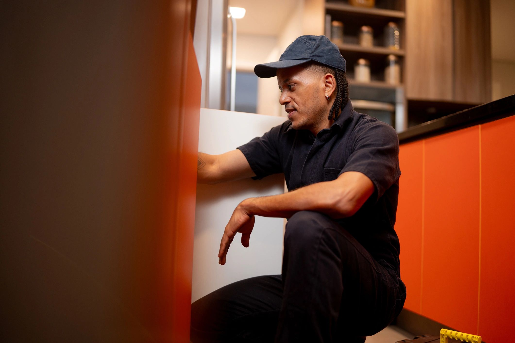 Technician performing HVAC service in a home